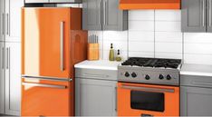 an orange and grey kitchen with stainless steel appliances