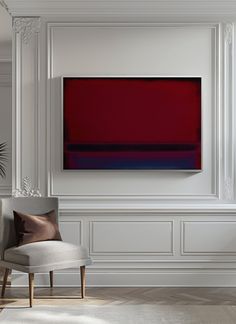 a living room with white walls and a red painting on the wall