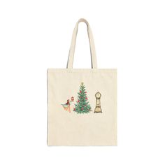 a tote bag with a christmas tree and chickens in front of it, on a white background