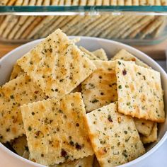 a bowl filled with crackers sitting on top of a table