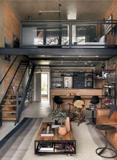 a living room filled with furniture next to a stair case in a loft style home