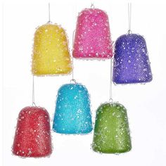 six different colored bell ornaments hanging from strings