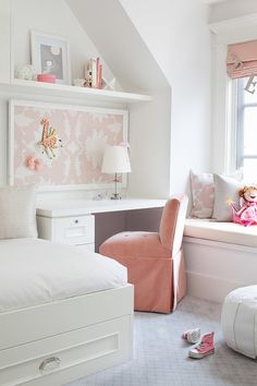 a bedroom with pink and white decor in the corner