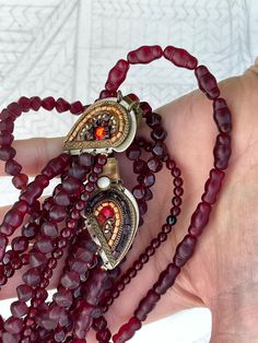 Vintage 4-strand glass bead necklace made by Ayala Bar.  Garnet-colored glass beads of various sizes and shapes   Elaborate clasp with beads and stones.  Measures 16.5 inches. The strands don't lie flat, as you can see from the photo, and could be twisted.  In good used condition. Glass Bead Necklace, Glass Bead, Bead Necklace, Colored Glass, Garnet, Necklace Etsy, Glass Beads, Beaded Necklace, Jewelry Necklaces