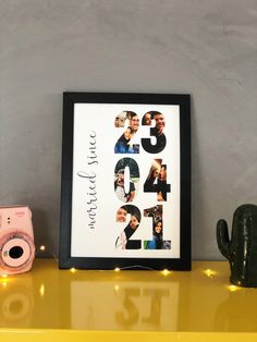 a yellow shelf with a black framed photo and a pink camera on it next to a cactus