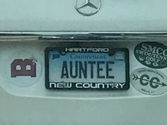 a mercedes license plate with stickers on the front and back of it that says, auntee new country