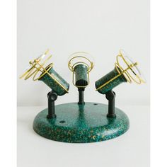 two green and gold microphones sitting on top of a stand