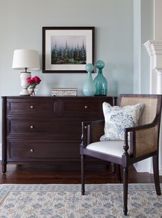 a living room scene with focus on the dresser and chair in the foreground,