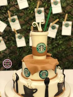 there is a cake with starbucks coffee cups on it and paper clips stuck to the top