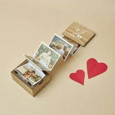 an open box with pictures and hearts on it