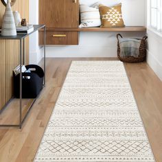 a large white rug in the middle of a room with wooden cabinets and shelves behind it