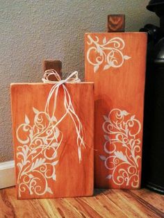 two wooden bags with white designs on them sitting next to a coffee pot and kettle