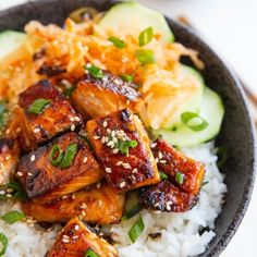 a bowl filled with rice, meat and vegetables