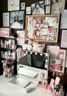 a white desk topped with a mirror and lots of clutter