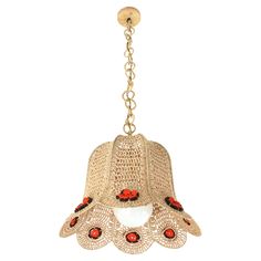 a chandelier hanging from the ceiling with red beads on it's arms