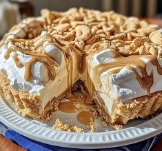 a dessert is on a white plate with caramel drizzles and nuts