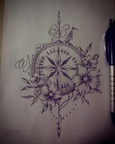 a drawing of a compass with flowers on it