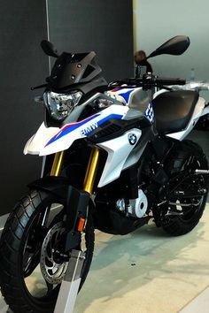 a white and blue motorcycle is on display