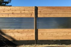 a wooden fence with metal slats on it