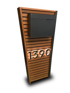 a wooden wall mounted mailbox with the number 1300 on it's side