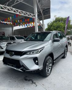 a silver suv parked in front of a building