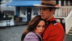 a man in uniform hugging a woman on the street