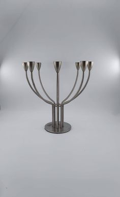 a large metal candelabra with five candles on it's sides and four lights in the middle