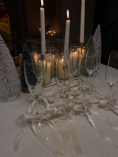 a table topped with lots of wine glasses and candles