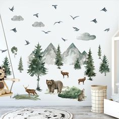 a wall with animals and birds painted on it in a child's nursery room