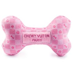 a pink dog bone with the name chewy vutton paris on it's side