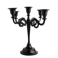 a black candelabra with three candles on it