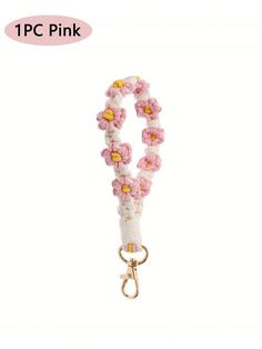 a pink and white lanyard with flowers attached to it's side, on a white background