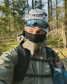 a man wearing a face mask in the woods