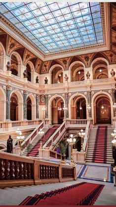 the inside of a building with many stairs and chandeliers on each side of it