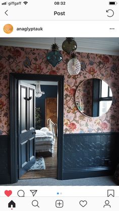 an open door leading to a bedroom with floral wallpaper