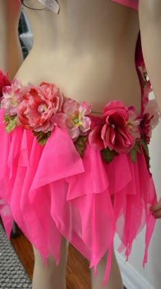 there is a mannequin wearing a pink skirt with flowers on the bottom and sides