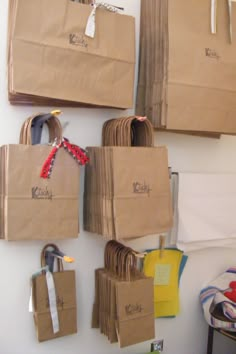 several brown paper bags hanging on the wall