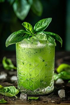 a green drink with leaves on the rim