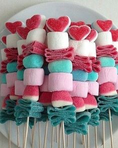 marshmallows are arranged on top of toothpicks in the shape of hearts