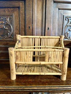 a wooden bench sitting on top of a wooden table next to a wall with carved wood paneling