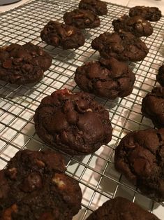 several chocolate cookies cooling on a wire rack