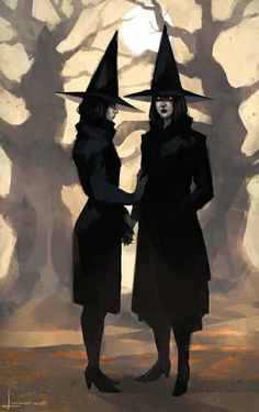 two women dressed in witches standing next to each other