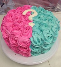 there is a cake that has been decorated with pink and blue icing on it