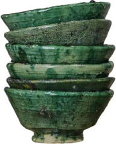 a stack of green bowls sitting on top of each other