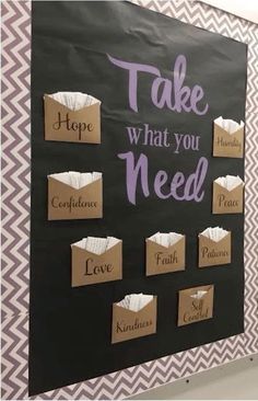 a bulletin board that says take what you need with some paper bags attached to it