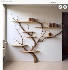 there is a tree with books on it in the corner of this room, and some shelves are made out of branches