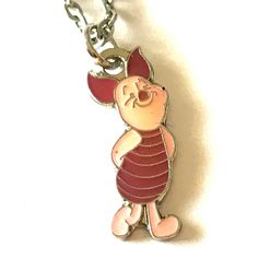 a winnie the pooh keychain is shown on a white surface with a chain