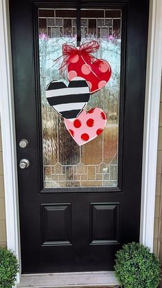 the front door is decorated with three hearts