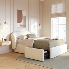 a white bed sitting on top of a hard wood floor next to a large window