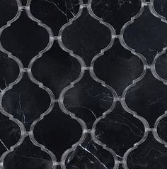 a black marble tile with an intricate design